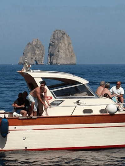 a group of people in a small boat in a body of water