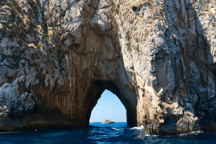 water next to the rock with Arch of Cabo San Lucas in the background